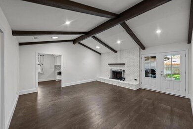 Unfurnished living room with french doors, vaulted