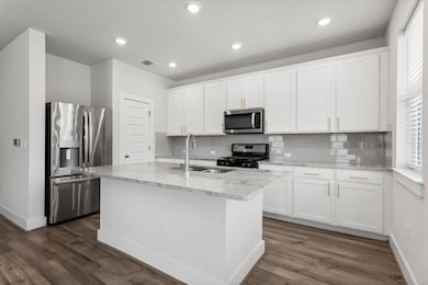 Kitchen with stainless steel appliances, a sink, 