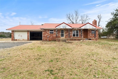Ranch-style house featuring a garage and a front y