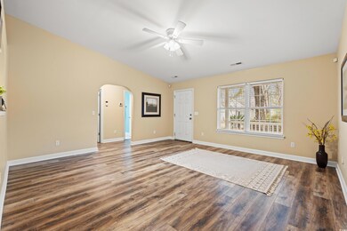 Entryway with dark wood-style floors, visible vent