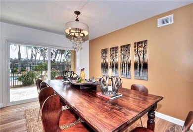 Dining room with beautiful chandelier, wood floor 