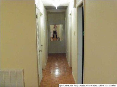 Hallway with parquet floors. Three bedrooms and on