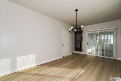 Unfurnished room with a chandelier and light wood-type flooring