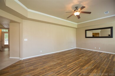 Family Room features tray ceiling with ceiling fan