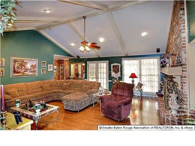 Very large den with wall built ins and fireplace. 