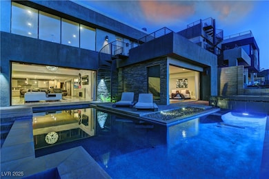 Outdoor pool featuring a balcony, a jacuzzi, and a patio