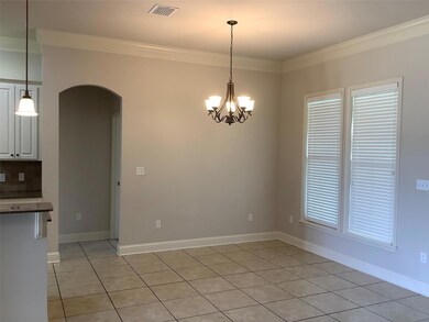 Tiled empty room with crown molding, a wealth of n