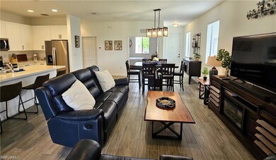 Living area with wood tiled floor, baseboards, and