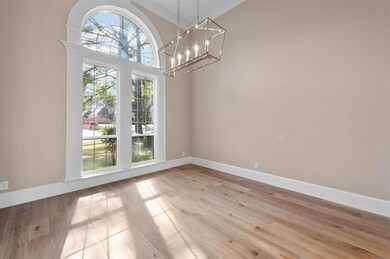 Spacious formal dining opens to formal living
