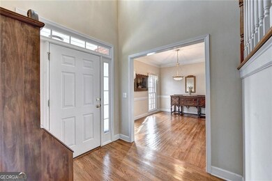 Entryway featuring crown molding, wood finished fl