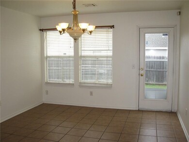 The dining room and kitchen feature neutral colore