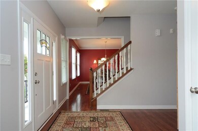 The inviting entry offers gleaming red oak stained