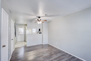 Empty room featuring dark wood finished floors and a ceiling fan