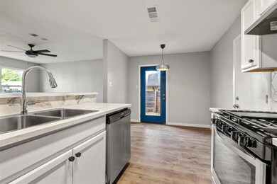Kitchen with dishwasher, range with gas cooktop, 