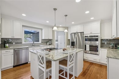 Bright, remodeled kitchen with custom cabinetry and stone countertops