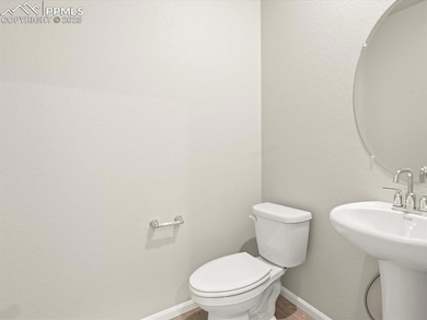 Bathroom with toilet, sink, and hardwood / wood-st