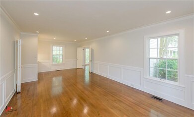 Elegant living room with crown molding, recessed l
