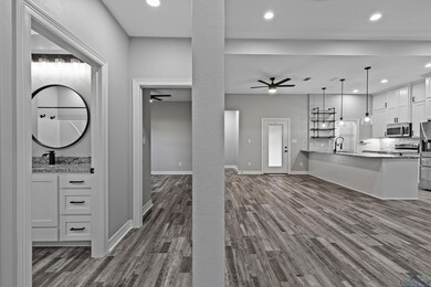 Unfurnished living room featuring dark hardwood / 