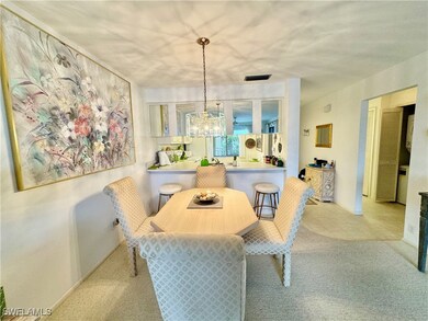 Carpeted dining space featuring a chandelier