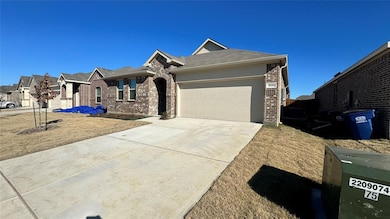 View of front of house with brick siding, an attached garage, concrete driveway, and a shingled roof