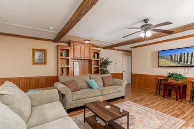 Living room featuring ceiling fan, light hardwood 