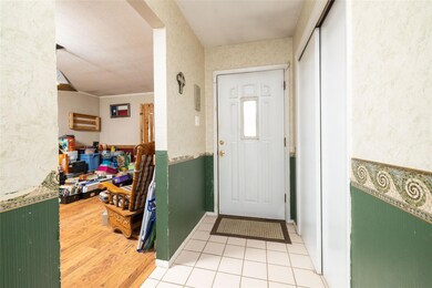 Living room featuring carpet flooring, a textured 