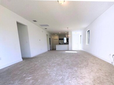 Unfurnished living room with light colored carpet,