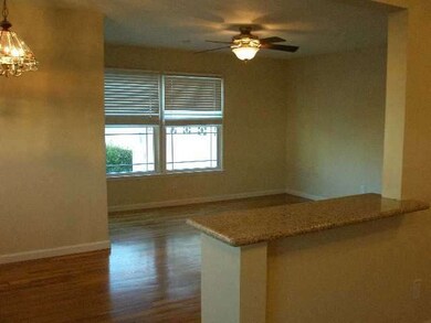 Looking from kitchen. Refinished wood floors.