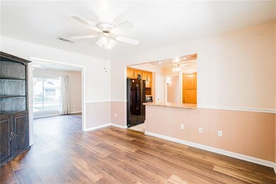 Breakfast nook with view of the living room, kitchen and back covered patio.
