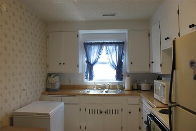 Shown with space freezer and kitchen table.