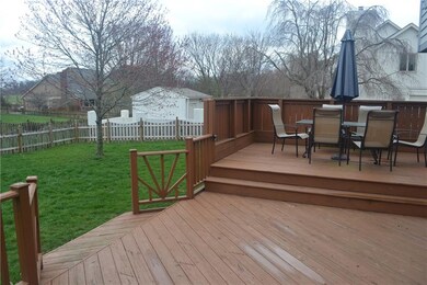 Main level deck steps out to fenced backyard.