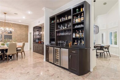 Wet bar featuring wine cooler, mini fridge and ice maker