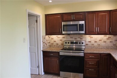 Kitchen is large enough for a small table. The doo