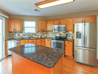 Spacious kitchen boasts beautiful granite counters