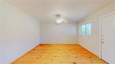 Empty room featuring light wood-type flooring, orn