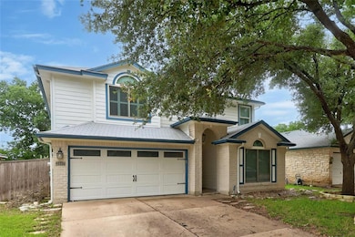 Traditional home with driveway, fence, a garage, 