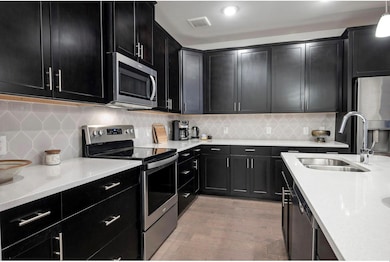 Kitchen with hanging light fixtures, light wood-ty