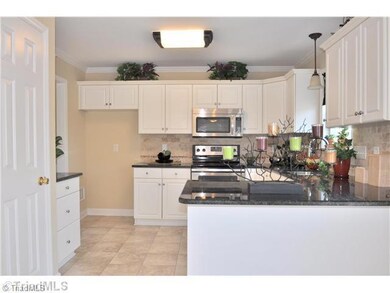 Kitchen. Newly remodeled eat-in Kitchen features new granite counters, new stainless steel appliances and new tile backsplash.