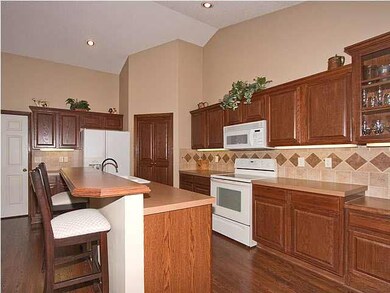 Great kitchen with eating bar and pretty woodwork