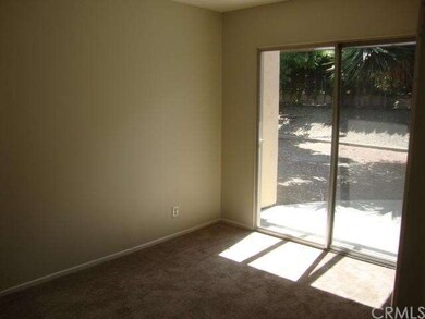 The secondary bedroom features sliding glass doors
