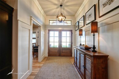 Entryway with a chandelier, crown molding, french 