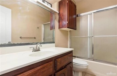 Full bath with vanity, enclosed tub / shower combo, and tile patterned flooring