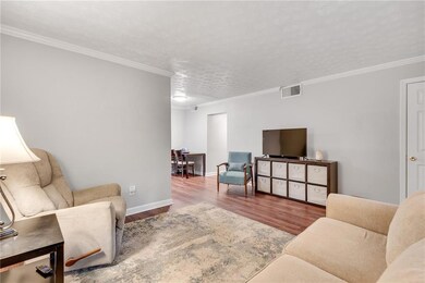 Living area featuring wood finished floors, basebo