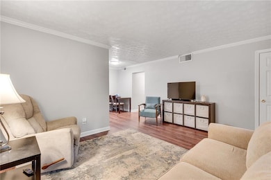 Living area featuring wood finished floors, basebo