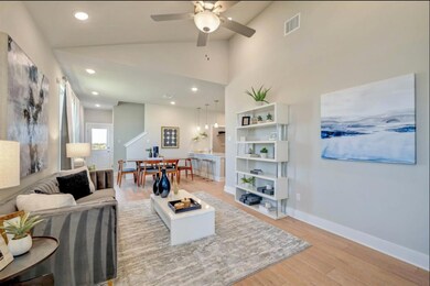 Living area with recessed lighting, visible vents