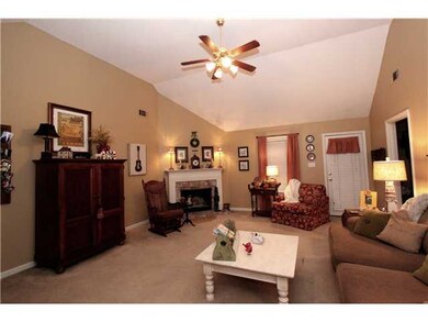 Vaulted greatroom with corner fireplace.