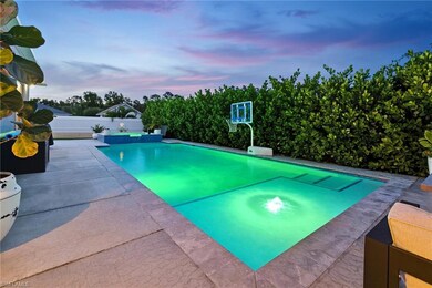 View of pool featuring a fenced backyard, a patio area, and a pool with connected hot tub