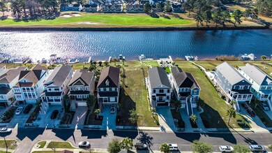 Birds eye view of property with a water view and a residential view