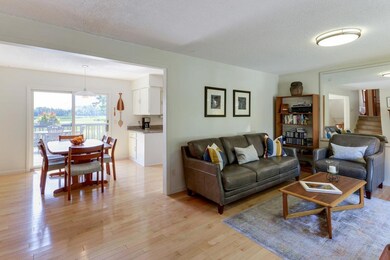 Open concept living and dining room with silver ma