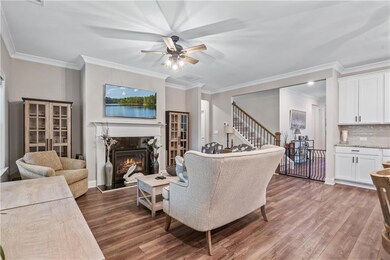 Living room featuring a lit fireplace, wood finish